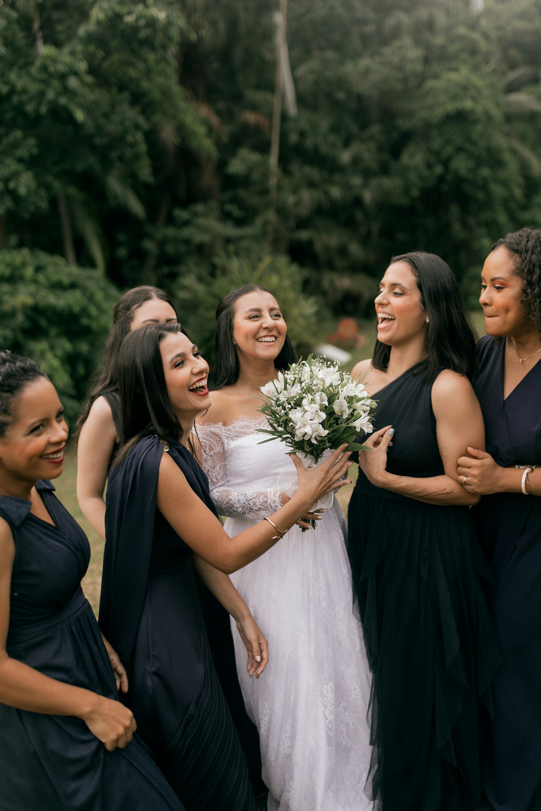 A bride laughing with her bridesmaids