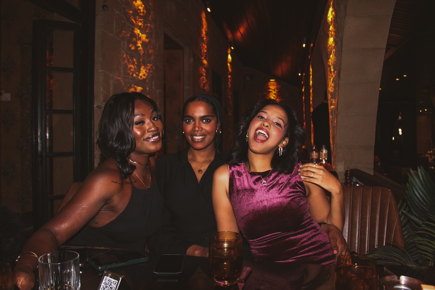 Three friends enjoying an evening together over drinks